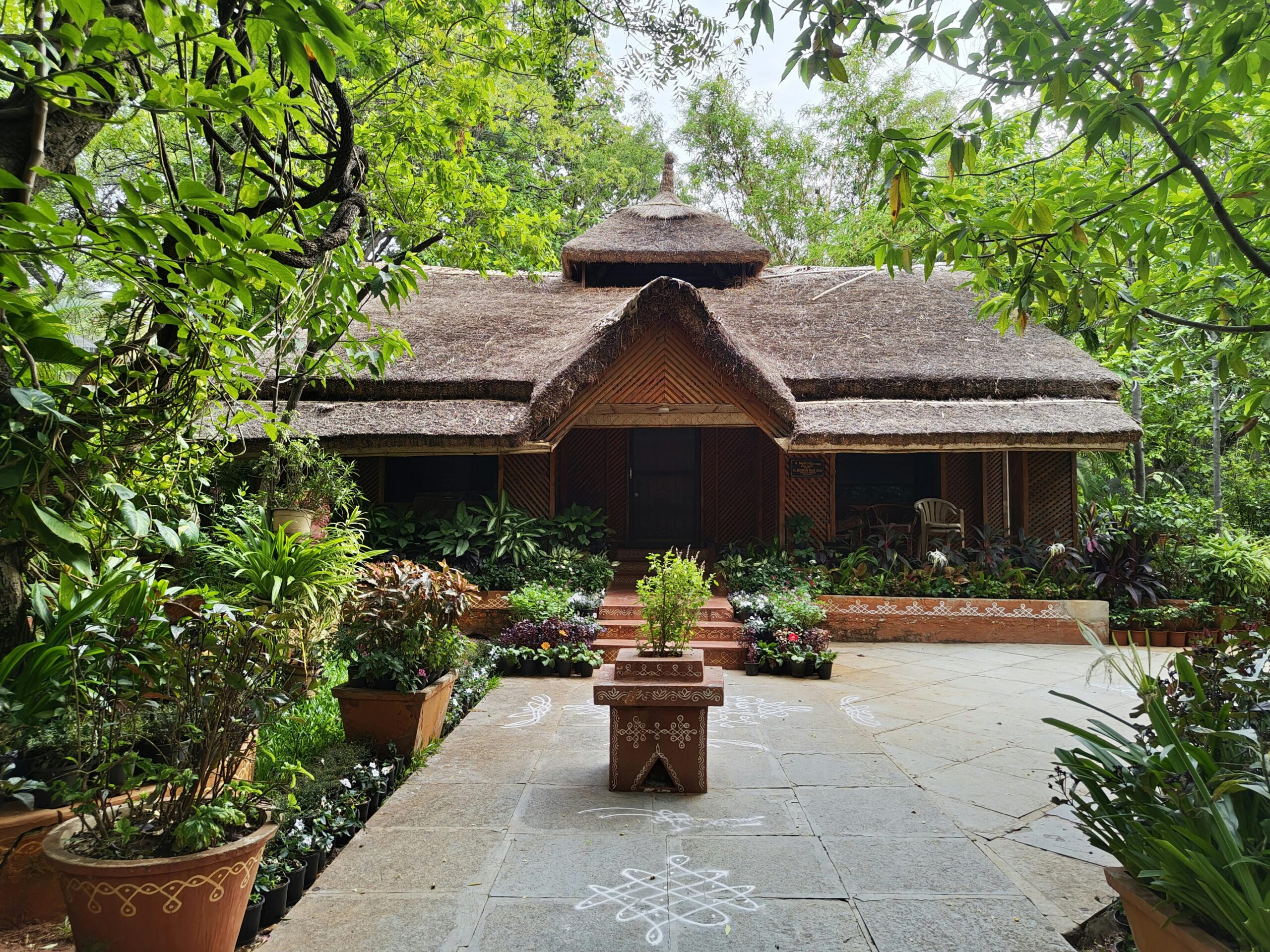 A charming traditional Indian house surrounded by lush greenery in Hyderabad, India.