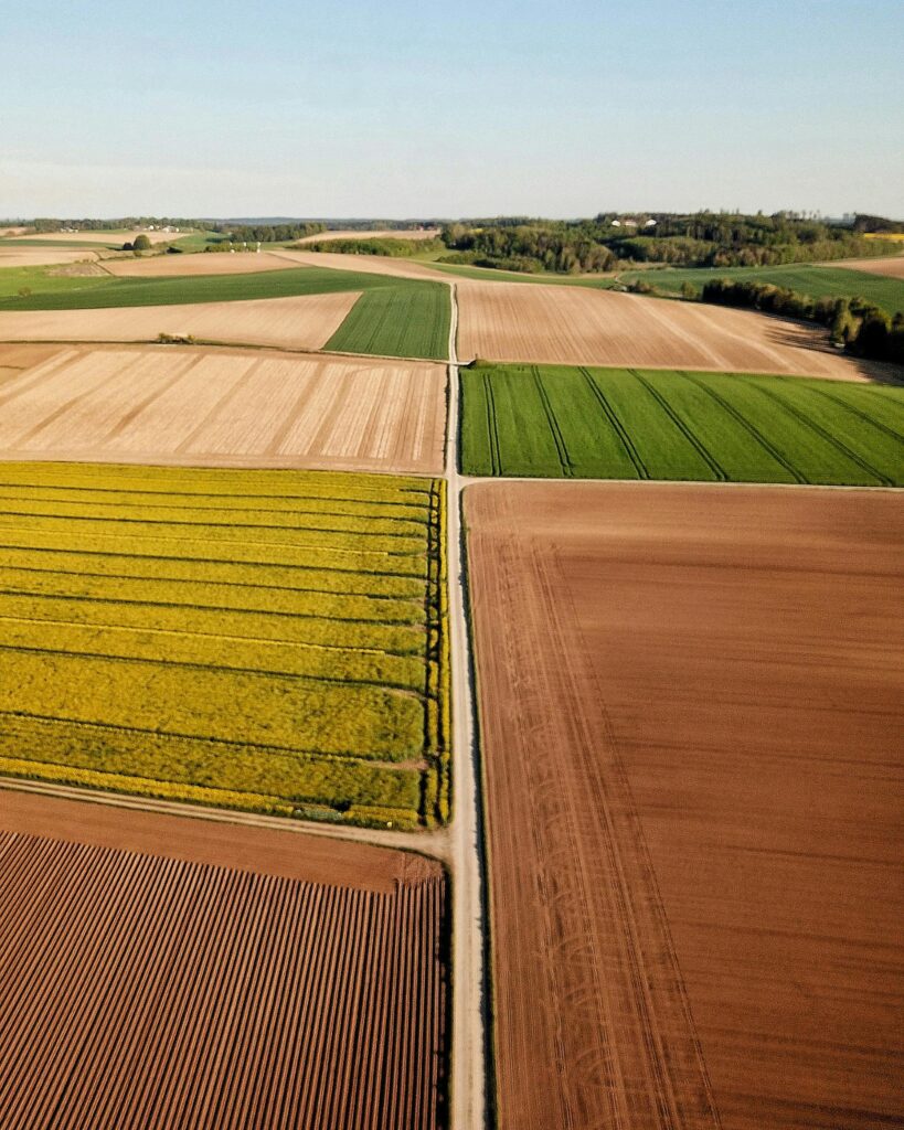 A vibrant aerial shot of diverse farmland patterns in Wallersdorf, Germany.